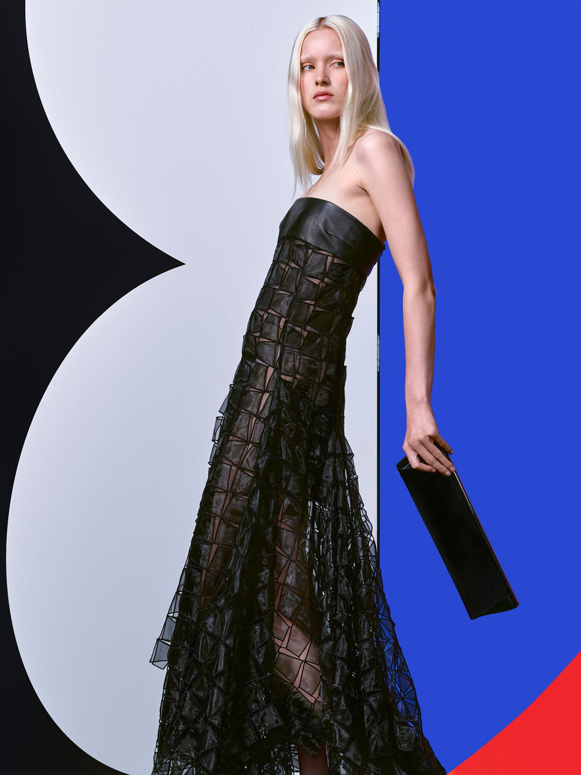 Akris Spring/Summer gown featuring intricate geometric embroidery and a structured grid pattern. The focus is on the architectural craftsmanship and sheer, textured fabric details.