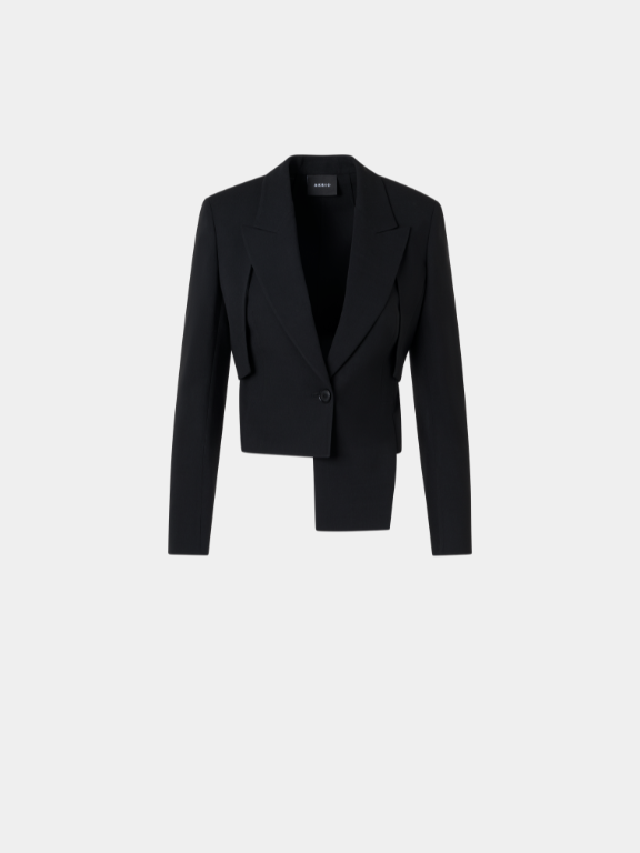 Sophisticated black cropped blazer featuring a sharp asymmetric hemline and peak lapels. Designed with a modern structured silhouette and a unique layered panel on one side. Single-button closure providing a refined, avant-garde aesthetic for professional attire.