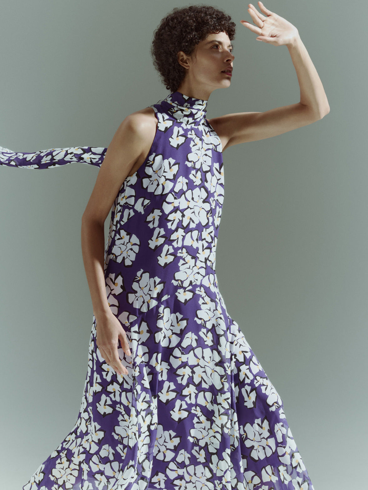 Model wearing a sleeveless high-neck top with a purple and white floral print from the Akris punto Pre-Fall 2026 collection.